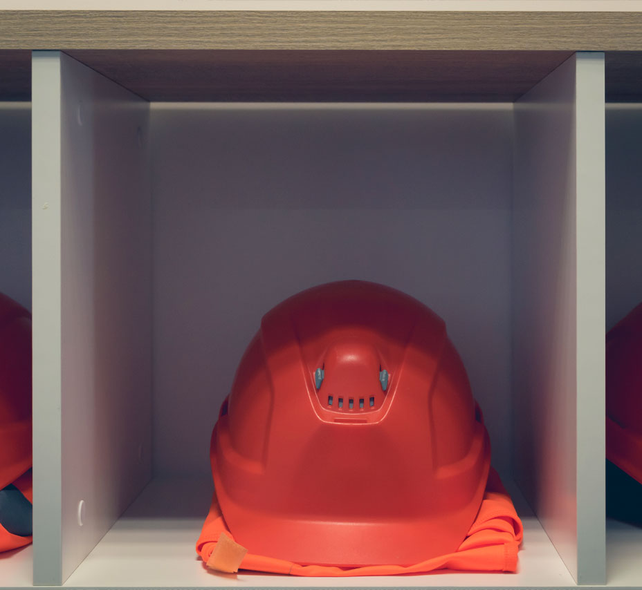Red hard hats on shelf