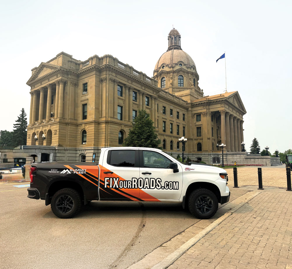 Summit Fleet truck with FixOurRoads.com decal parked in front of legislative building